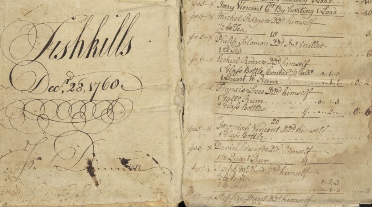 Photo of a tattered, yellow ledger from a story from 1760, including entries for rum, tea and other products and the customers who purchased them.